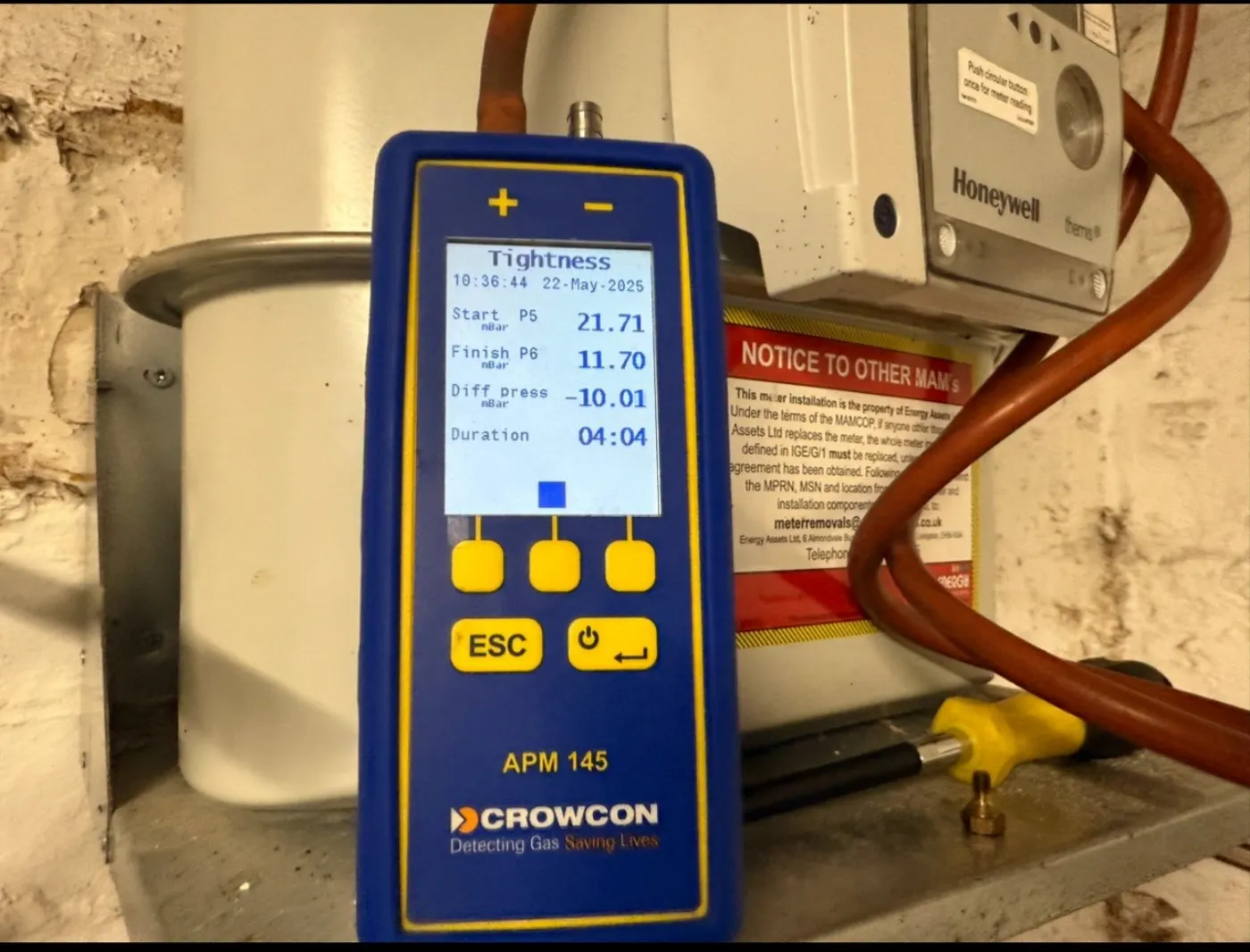 Engineer running a Crowcon tightness test on a gas boiler for leak detection