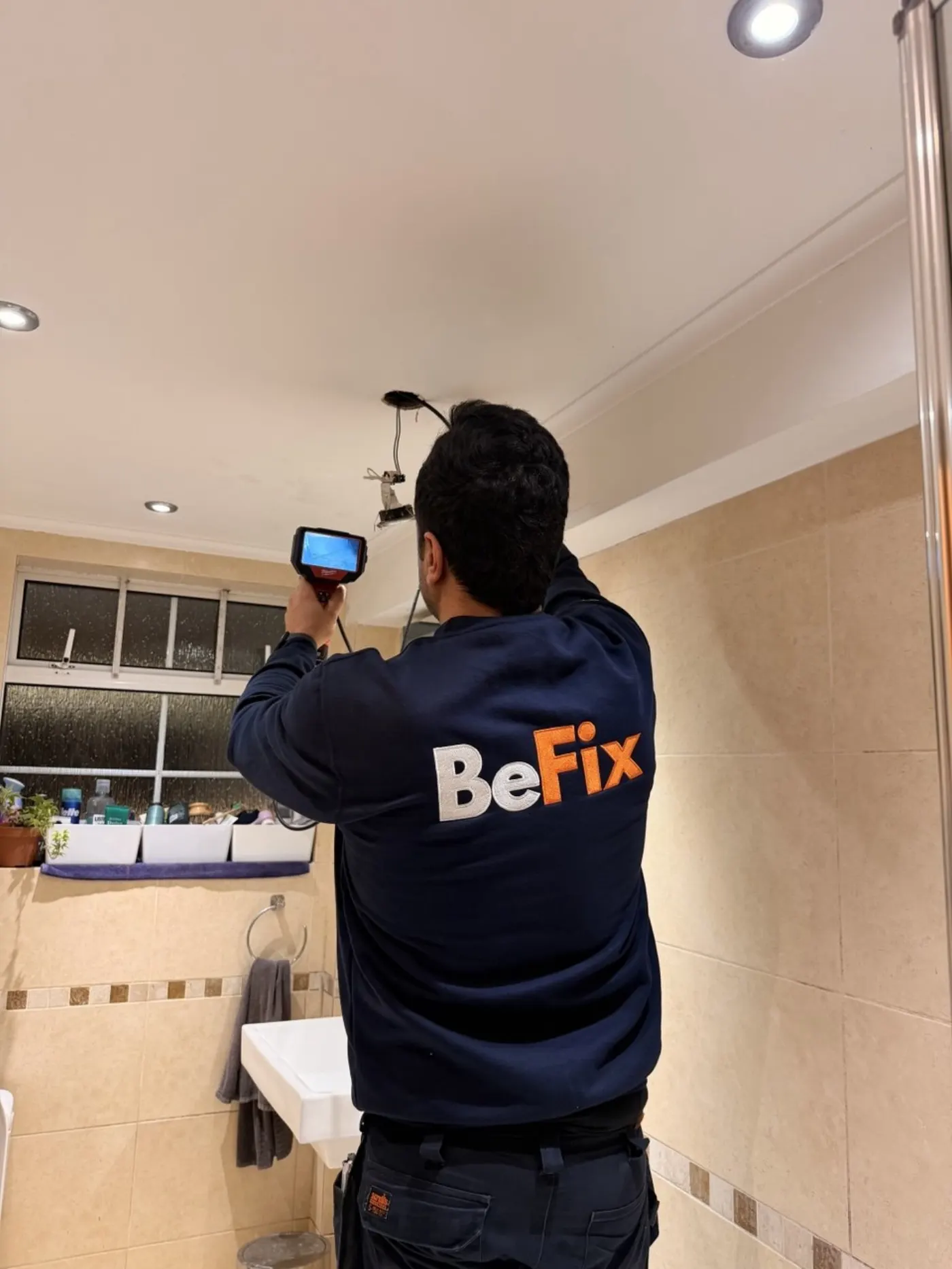 BeFix engineer inspecting a bathroom with a borescope for water leak detection